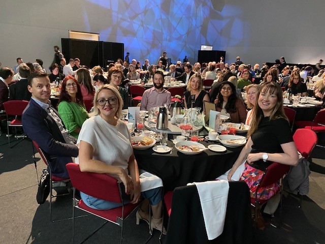 LSA staff members sitting at a table at the Adelaide White Ribbon Breakfast.