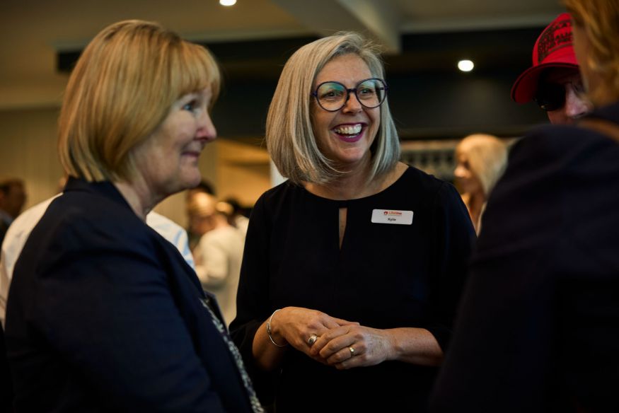 three female in conversation