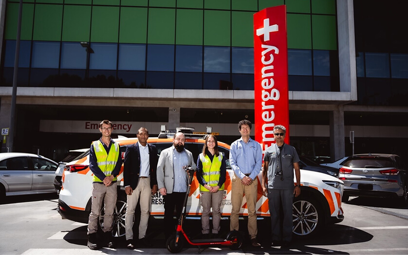 Group of people standing in front of e-scooter bike